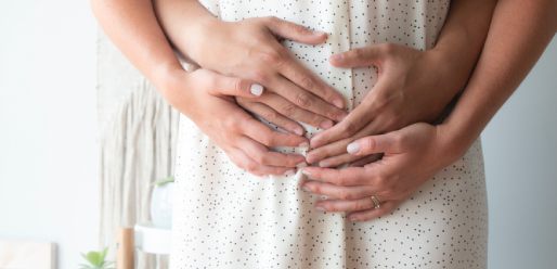 Holding pregnant belly 