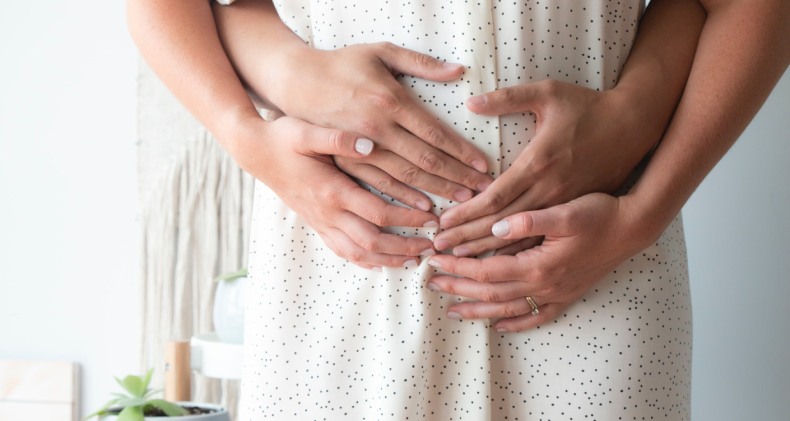 Holding pregnant belly 
